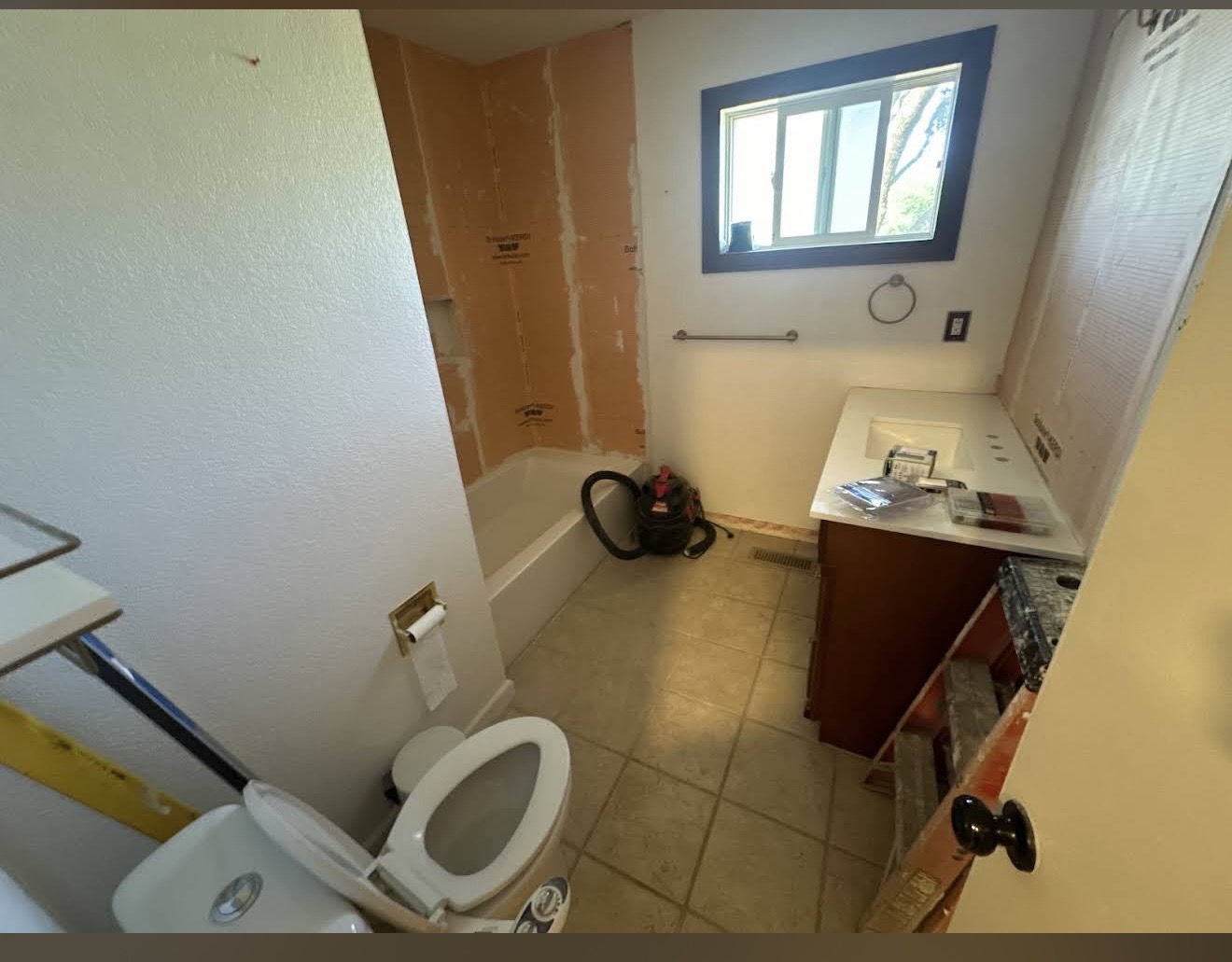 The bathroom before — empty, ready for demolition.