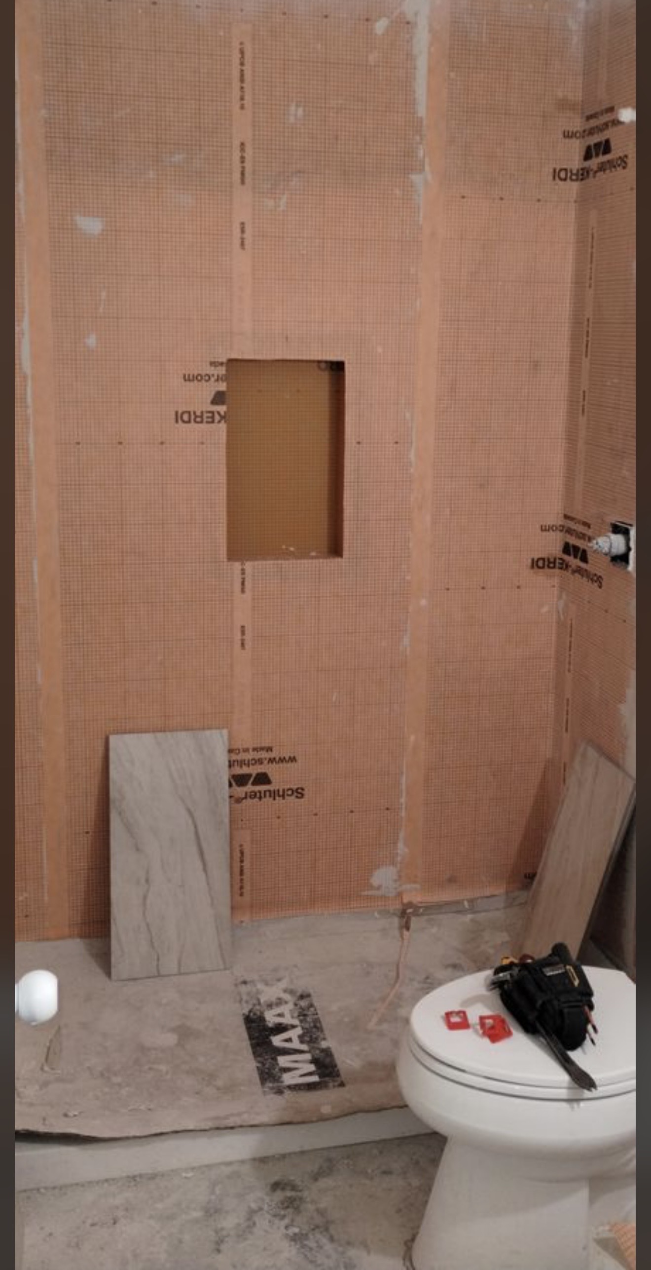 The same bathroom during construction, with Schluter Kerdi waterproofing membrane installed.